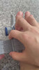 Bunion corrector held in hand showing the silicone pad